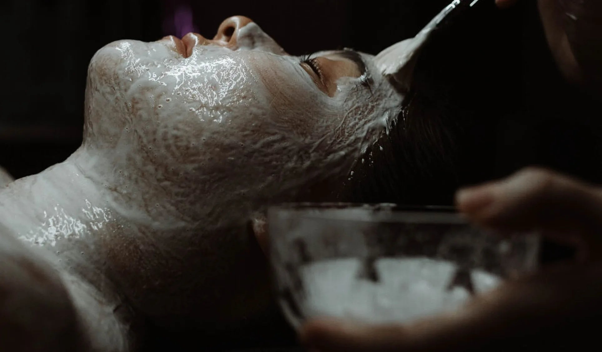 A client resting during a treatment while a mask is applied.